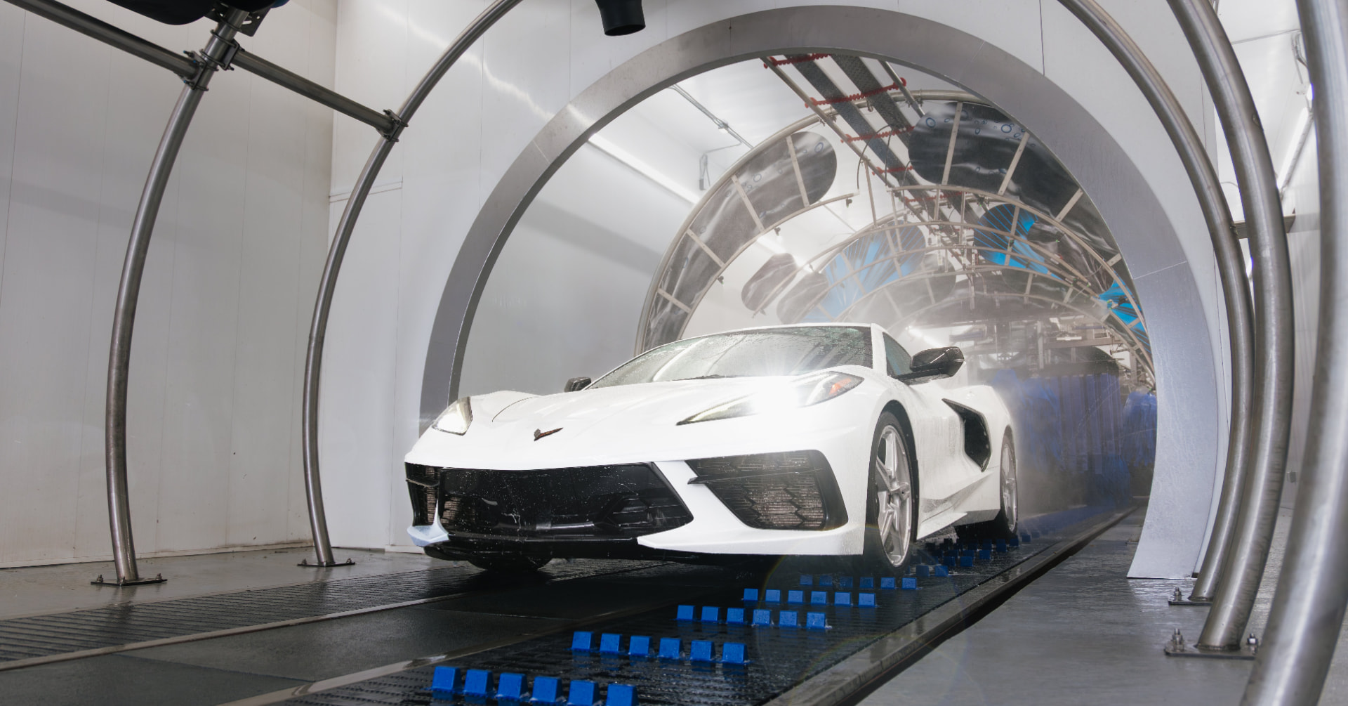 White sports car moving through the Zoom Wash express tunnel in Knoxville TN